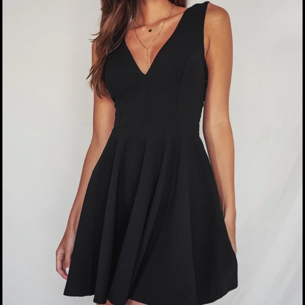 Lulus White Deep V neck A-Line Dress. Fitted on top, flares beautifully. Size L